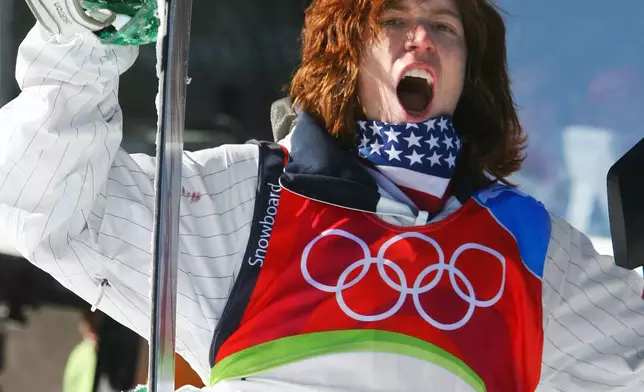 FILE - United States Shaun White reacts after seeing his score on the first run of the Men's Halfpipe Snowboard competition at the Turin 2006 Winter Olympic Games in Bardonecchia, Italy Sunday, Feb. 12, 2006. White's 46.8 held up to give him the gold medal. (AP Photo/Lionel Cironneau, File)