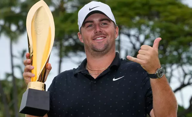 Chris Gotterup holds his trophy after winning the Sony Open golf event at the Waialae Country Club in Honolulu, Sunday, Jan. 18, 2026. (AP Photo/Matt York)