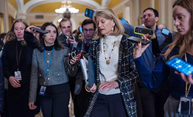 Sen. Lisa Murkowski, R-Alaska, a member of the Senate Appropriations Committee, is surrounded by reporters following a closed-door Republican meeting on spending legislation that funds the Department of Homeland Security and a swath of other government agencies, at the Capitol in Washington, Wednesday, Jan. 28, 2026. (AP Photo/J. Scott Applewhite)