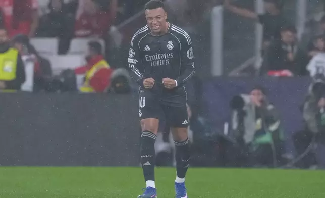 Real Madrid's Kylian Mbappe celebrates after scoring the opening goal during a Champions League opening phase soccer match between Benfica and Real Madrid, in Lisbon, Wednesday, Jan. 28, 2026. (AP Photo/Armando Franca)