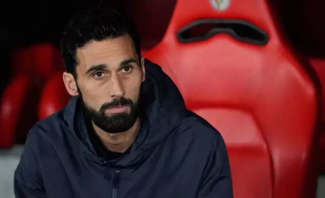 Real Madrid's head coach Alvaro Arbeloa sits at the bench before a Champions League opening phase soccer match between Benfica and Real Madrid, in Lisbon, Wednesday, Jan. 28, 2026. (AP Photo/Armando Franca)