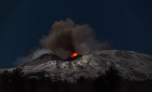 Explosive activity concentrates at the north-east crater of the Mount Etna, as an eruption started on Dec. 24 continues, in Sicily, Italy, Monday Dec. 29, 2025. (AP Photo/Salvatore Allegra)