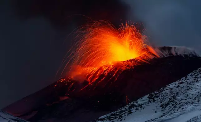Explosive activity concentrates at the north-east crater of the Mount Etna, as an eruption started on Dec. 24 continues, in Sicily, Italy, Monday Dec. 29, 2025. (AP Photo/Salvatore Allegra)