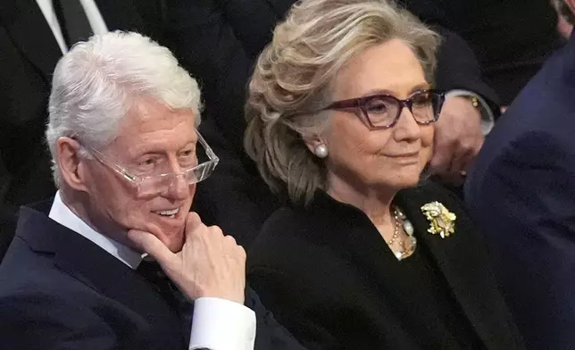 FILE - Former President Bill Clinton and former Secretary of State Hillary Clinton listen during the state funeral for former President Jimmy Carter at Washington National Cathedral in Washington, Jan. 9, 2025. (AP Photo/Jacquelyn Martin, File)
