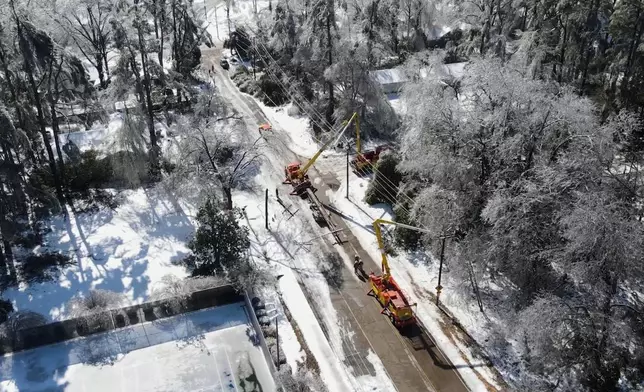 This image taken from a video released by the city of Oxford, Miss., shows crews working on power lines Tuesday, Jan. 27, 2026. (City of Oxford Mississippi via AP)