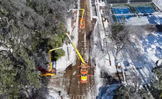 This image taken from a video released by the city of Oxford, Miss., shows crews working on power lines Tuesday, Jan. 27, 2026. (City of Oxford Mississippi via AP)