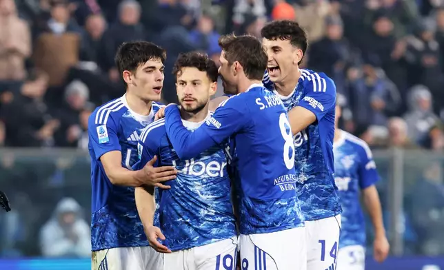 Como's Nicolas Kuehn, second left, celebrates scoring with teammates during the Serie A soccer match between Como and Torino in Como, Italy, Saturday Jan. 24, 2026. (Antonio Saia/LaPresse via AP)