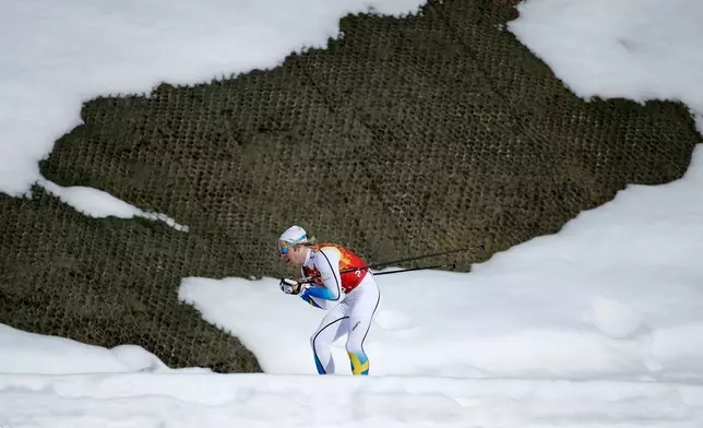 FILE - Sweden's Lars Nelson skis past a hole in the snow during the men's 4x10K cross-country relay at the 2014 Winter Olympics, Sunday, Feb. 16, 2014, in Krasnaya Polyana, Russia. (AP Photo/Gregorio Borgia, File)