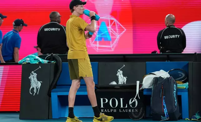 Jannik Sinner of Italy takes a drink during his third round match against Eliot Spizzirri of the U.S. at the Australian Open tennis championship in Melbourne, Australia, Saturday, Jan. 24, 2026. (AP Photo/Dita Alangkara)