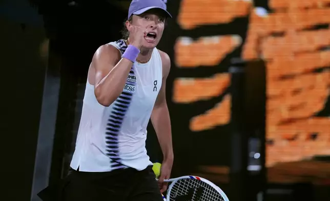 Iga Swiatek of Poland reacts after defeating Anna Kalinskaya of Russia in their third round match at the Australian Open tennis championship in Melbourne, Australia, Saturday, Jan. 24, 2026. (AP Photo/Aaron Favila)