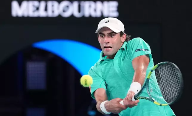 Eliot Spizzirri of the U.S. plays a backhand return to Jannik Sinner of Italy during their third round match at the Australian Open tennis championship in Melbourne, Australia, Saturday, Jan. 24, 2026. (AP Photo/Dita Alangkara)
