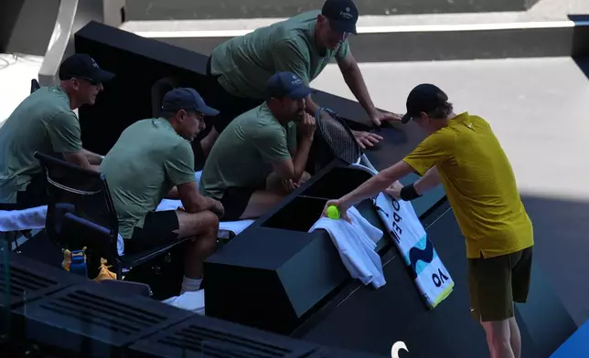 Jannik Sinner of Italy rests at his coaching box during his third round match against Eliot Spizzirri of the U.S. at the Australian Open tennis championship in Melbourne, Australia, Saturday, Jan. 24, 2026. (AP Photo/Dita Alangkara)