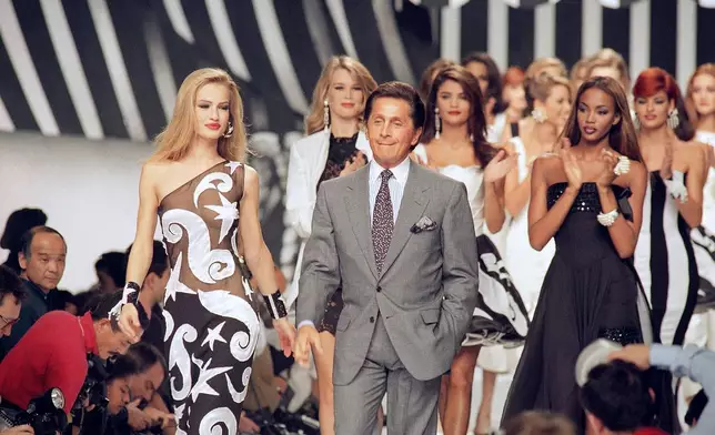 FILE - Italian fashion designer Valentino Garavani walks the catwalk with his models after a fashion show on October 20, 1991 in Paris, France. (AP Photo/Remy de la Mauviniere, File)