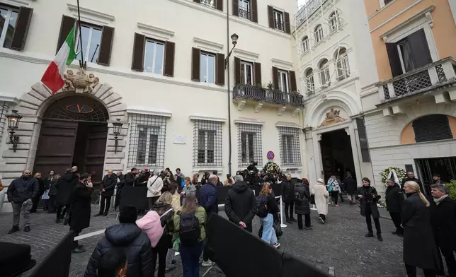People arrive to pay their respects to fashion designer Valentino Garavani, lying in state at the Valentino Garavani and Giancarlo Giammetti foundation headquarters in central Rome, Wednesday Jan. 21, 2026. (AP Photo/Andrew Medichini)