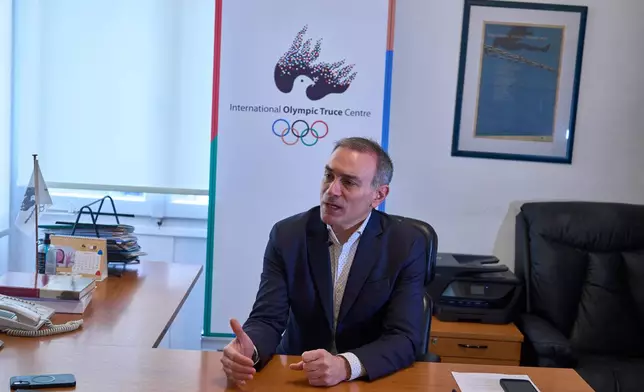 The Director of the International Olympic Truce Centre Constantinos Filis speak to the Associated Press during an interview in Athens, Jan. 28, 2026. (AP Photo/Petros Giannakouris)
