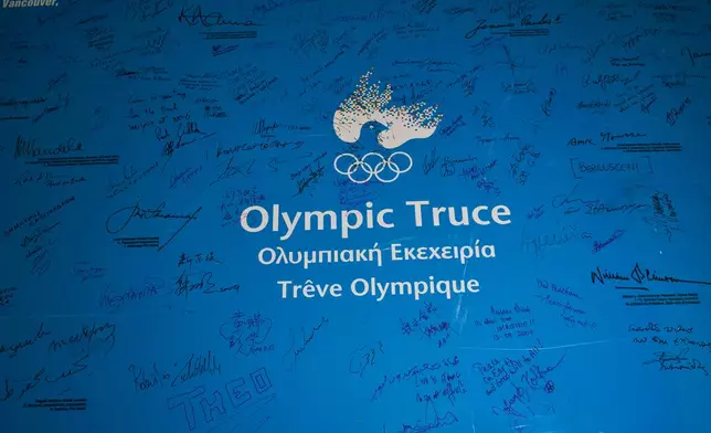 A board bearing signatures of athletes, leaders and public figures, in support of the Olympic Truce is displayed inside the Athens Olympic Museum on Jan. 28, 2026. (AP Photo/Petros Giannakouris)