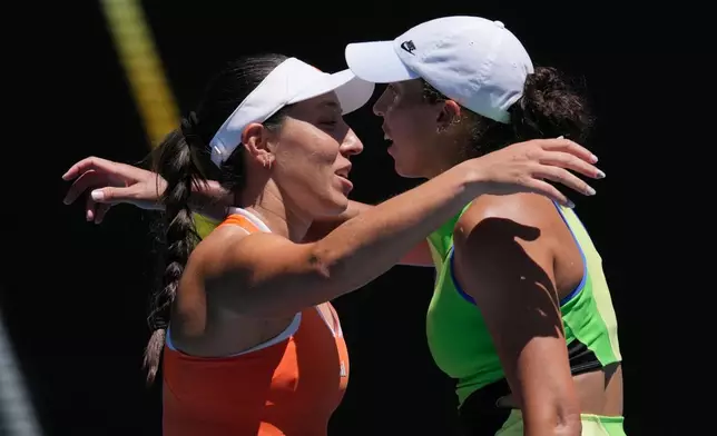 Jessica Pegula, left, of the U.S., is congratulated by her compatriot Madison Keys after winning their fourth round match at the Australian Open tennis championship in Melbourne, Australia, Monday, Jan. 26, 2026. (AP Photo/Mark Baker)