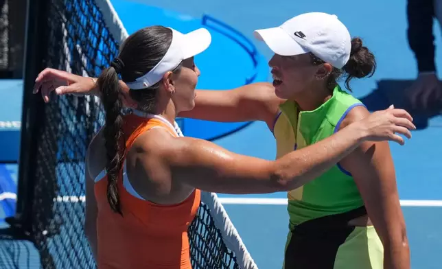 Jessica Pegula, left, of the U.S., is congratulated by her compatriot Madison Keys after winning their fourth round match at the Australian Open tennis championship in Melbourne, Australia, Monday, Jan. 26, 2026. (AP Photo/Asanka Brendon Ratnayake)