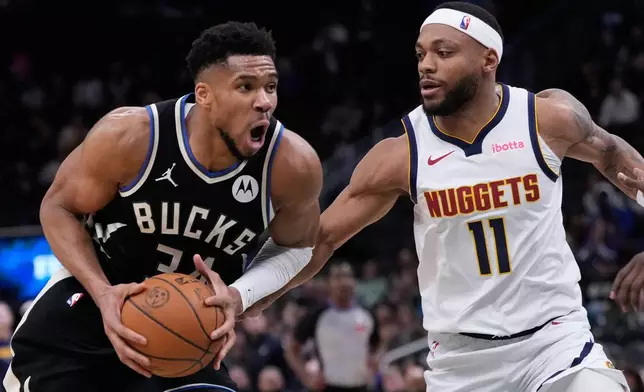 Milwaukee Bucks' Giannis Antetokounmpo tries to drive past Denver Nuggets' Bruce Brown during the second half of an NBA basketball game Friday, Jan. 23, 2026, in Milwaukee. (AP Photo/Morry Gash)
