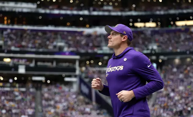 Minnesota Vikings head coach Kevin O'Connell runs onto the field before an NFL football game against the Green Bay Packers, Sunday, Jan. 4, 2026, in Minneapolis. (AP Photo/Ellen Schmidt)