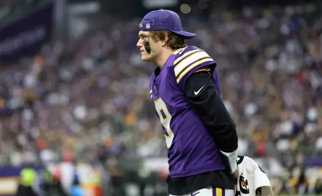 Minnesota Vikings quarterback J.J. McCarthy watches from the sideline during the second half of an NFL football game against the Green Bay Packers, Sunday, Jan. 4, 2026, in Minneapolis. (AP Photo/Ellen Schmidt)