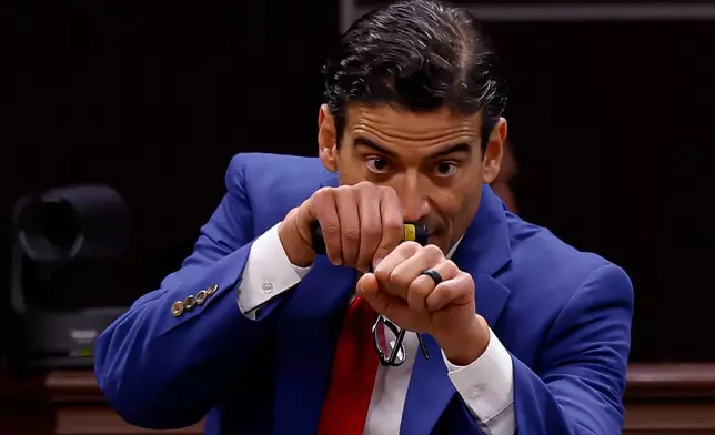 Defense attorney Nico LaHood mimics a police officer responding to a threat inside a classroom while delivering a closing statement to the jury on the 11th day of the trial for former Uvalde school district police officer Adrian Gonzales at the Nueces County Courthouse on Wednesday, Jan. 21, 2026, in Corpus Christi, Texas. (Sam Owens /The San Antonio Express-News via AP, Pool)