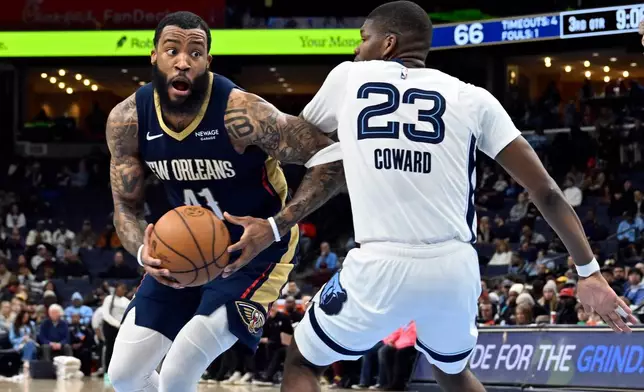 New Orleans Pelicans guard Saddiq Bey, left, handles the ball against Memphis Grizzlies forward Cedric Coward (23) in the second half of an NBA basketball game Friday, Jan. 23, 2026, in Memphis, Tenn. (AP Photo/Brandon Dill)