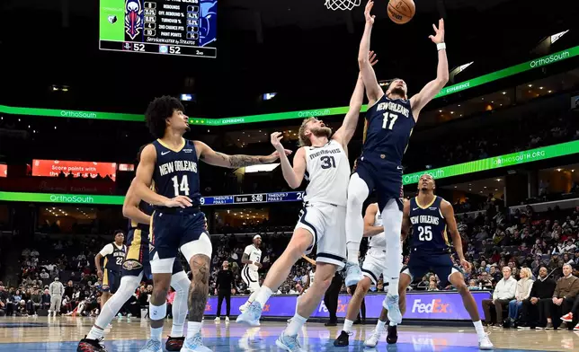 New Orleans Pelicans forward Karlo Matkovic (17) and Memphis Grizzlies center Jock Landale (31) jump for a rebound in the first half of an NBA basketball game Friday, Jan. 23, 2026, in Memphis, Tenn. (AP Photo/Brandon Dill)