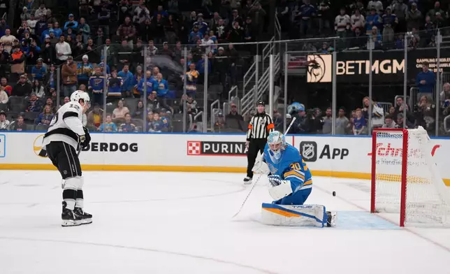 Los Angeles Kings' Trevor Moore (12) scores past St. Louis Blues goaltender Joel Hofer during a shootout of an NHL hockey game Saturday, Jan. 24, 2026, in St. Louis. (AP Photo/Jeff Roberson)