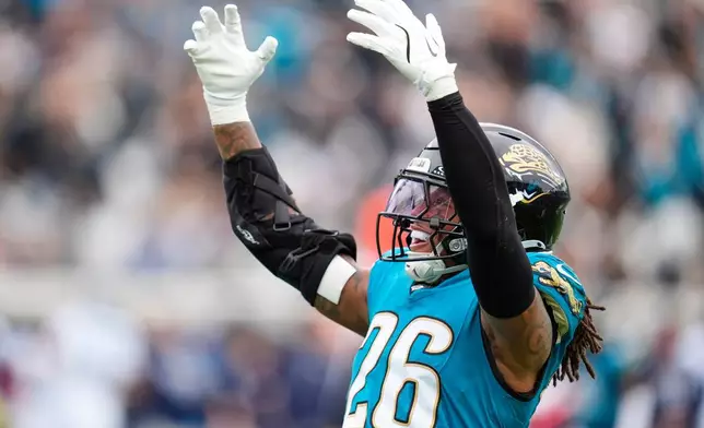 Jacksonville Jaguars safety Antonio Johnson (26) celebrates a defensive stop during the first half of an NFL football game against the Tennessee Titans, Sunday, Jan. 4, 2026, in Jacksonville, Fla. (AP Photo/John Raoux)