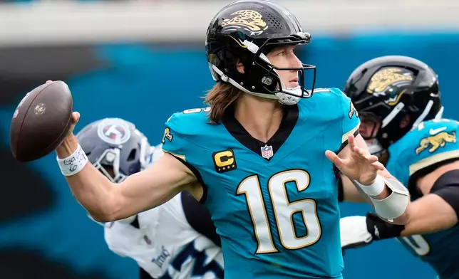 Jacksonville Jaguars quarterback Trevor Lawrence (16) looks to throw a pass during the first half of an NFL football game against the Tennessee Titans, Sunday, Jan. 4, 2026, in Jacksonville, Fla. (AP Photo/John Raoux)