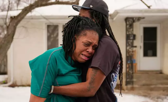 A family member reacts after federal immigration officers make an arrest Sunday, Jan. 11, 2026, in Minneapolis. (AP Photo/John Locher)