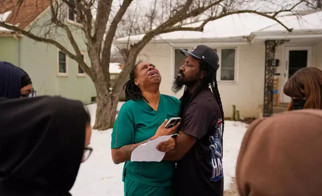 A family member reacts after federal immigration officers make an arrest Sunday, Jan. 11, 2026, in Minneapolis. (AP Photo/John Locher)