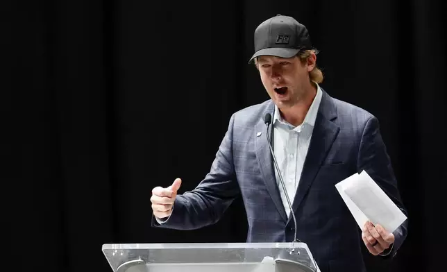 Garrett Mitchell speaks at the memorial service for former NASCAR driver Greg Biffle and his family in Charlotte, N.C., Friday, Jan. 16, 2026. (AP Photo/Nell Redmond)