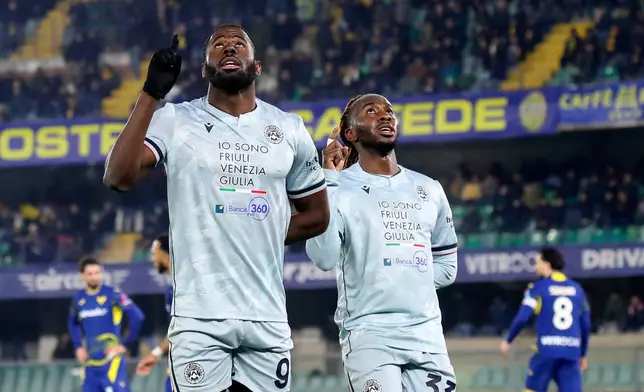 Udinese's Keinan Davis, left, celebrates after scoring their third goal during the Serie A soccer match between Hellas Verona and Udinese in Verona, Italy, Monday Jan. 26, 2026. (Paola Garbuio/LaPresse via AP)