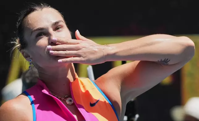 Aryna Sabalenka of Belarus celebrates after defeating Bai Zhuoxuan of China in their second round match at the Australian Open tennis championship in Melbourne, Australia, Wednesday, Jan. 21, 2026. (AP Photo/Dita Alangkara)