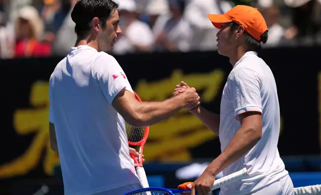 Learner Tien, right, of the U.S. is congratulated by Nuno Borges, left, of Portugal during their third round match at the Australian Open tennis championship in Melbourne, Australia, Friday, Jan. 23, 2026. (AP Photo/Dar Yasin)