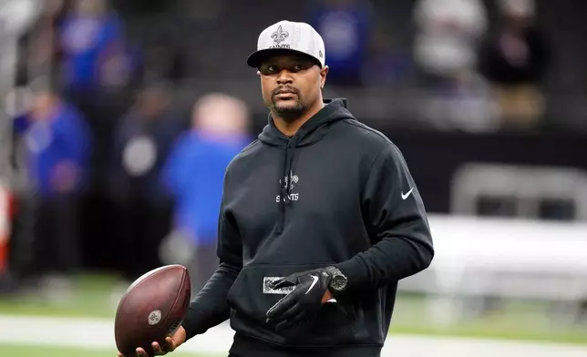 FILE - New Orleans Saints passing game coordinator/quarterbacks coach Ronald Curry walks on the field before an NFL football game against the New York Giants in New Orleans, Dec. 17, 2023. (AP Photo/Gerald Herbert, File)