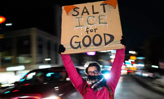 A protester rallies against the presence of U.S. Immigration Customs Enforcement in Maine, Friday, Jan. 23, 2026, in Portland, Maine. (AP Photo/Robert F. Bukaty)