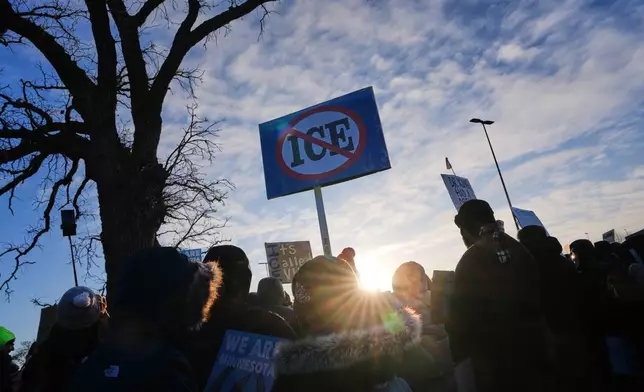 People gather for a protest outside the Bishop Henry Whipple Federal Building, Friday, Jan. 30, 2026, in Minneapolis. (AP Photo/Adam Gray)