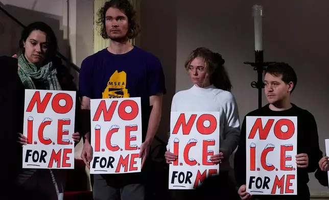 Attendees hold signs at a news conference held by public officials and faith leaders calling for the abolishment of the U.S. Immigrant and Customs Enforcement, Friday, Jan. 30, 2026, in Portland, Maine. (AP Photo/Robert F. Bukaty)