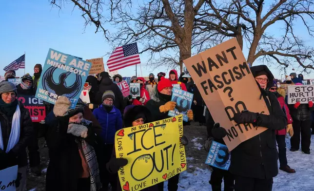 People gather for a protest outside the Bishop Henry Whipple Federal Building, Friday, Jan. 30, 2026, in Minneapolis. (AP Photo/Adam Gray)