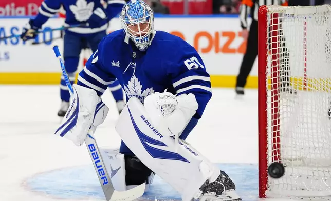 Toronto Maple Leafs goaltender Joseph Woll (60) makes a save against the Florida Panthers during first period NHL hockey action in Toronto on Tuesday, Jan. 6, 2026. (Frank Gunn/The Canadian Press via AP)