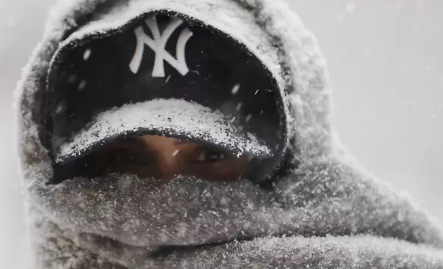 Abrar Omar walks through Manhattan during a winter storm, Sunday, Jan. 25, 2026, in New York. (AP Photo/Heather Khalifa)