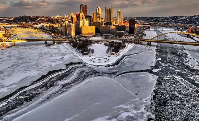 Ice covers the confluence of the Allegheny, left, Ohio, center, and Monongahela Rivers at the Point State Park in downtown Pittsburgh, Jan. 28, 2026. (AP Photo/Gene J. Puskar)