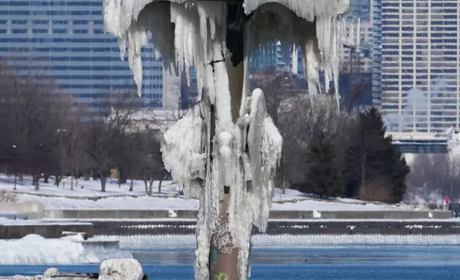 A harbor light is covered with snow and ice during a cold day in Chicago, Wednesday, Jan. 28, 2026. (AP Photo/Nam Y. Huh)