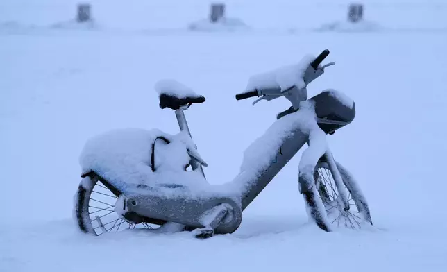 A bicycle is covered with scow at North Avenue beach in Chicago, Sunday, Jan. 25, 2026. (AP Photo/Nam Y. Huh)