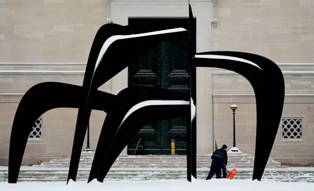 Workers shovel snow outside the National Gallery of Art, Sunday, Jan. 25, 2026, in Washington. (AP Photo/Julia Demaree Nikhinson)