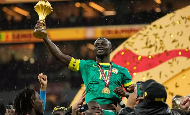 Senegal's Sadio Mane holds the trophy aloft after winning the Africa Cup of Nations final soccer match agaisnt Morocco, in Rabat, Morocco, Sunday, Jan. 18, 2026. (AP Photo/Mosa'ab Elshamy)