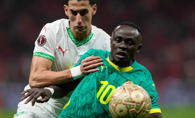 Senegal's Sadio Mane, front, and Morocco's Nayef Aguerd challenge for the ball during the Africa Cup of Nations final soccer match between Senegal and Morocco, in Rabat, Morocco, Sunday, Jan. 18, 2026. (AP Photo/Themba Hadebe)